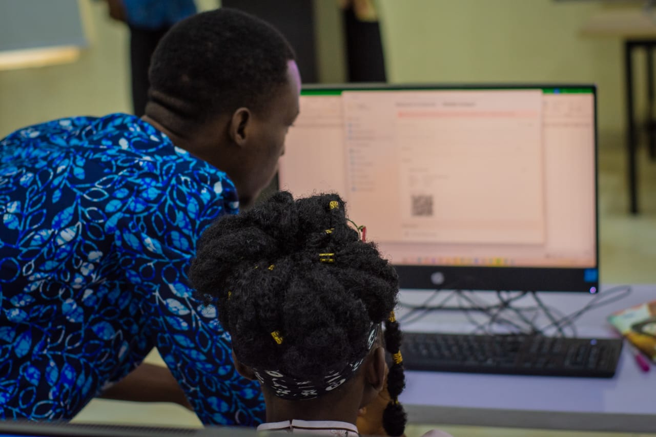 TechRangers mentor helping a student at a computer